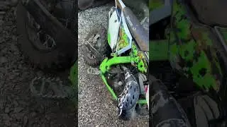 A mini dirt bike in a junkyard! 